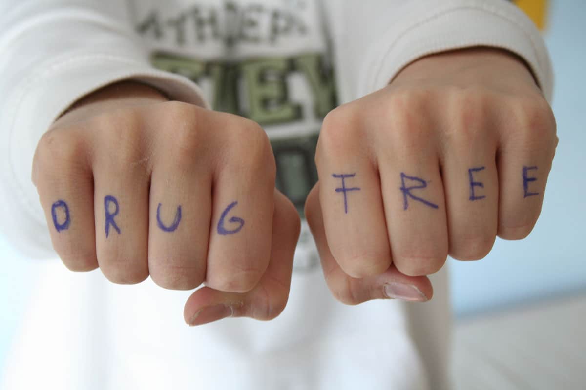 Two closed fists with Drug Free written on the outside of the fingers. 4U Health's Urine & Saliva Drug Test Kits can be used in a drug-free household program.